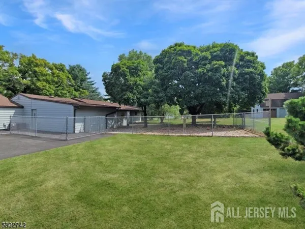 a view of a house with a backyard