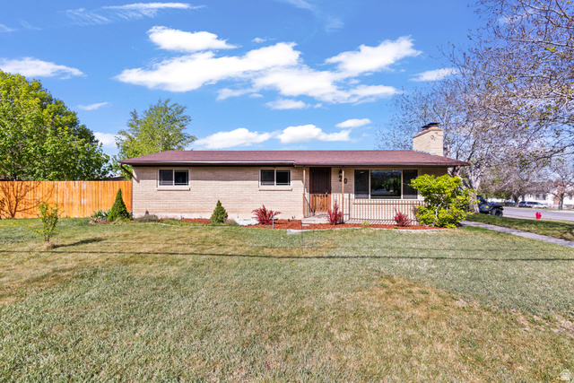 20 South Coleman Street Tooele, UT 84074 - Photo 1 of 1 Ranch-style home featuring brick siding, a porch, and a chimney