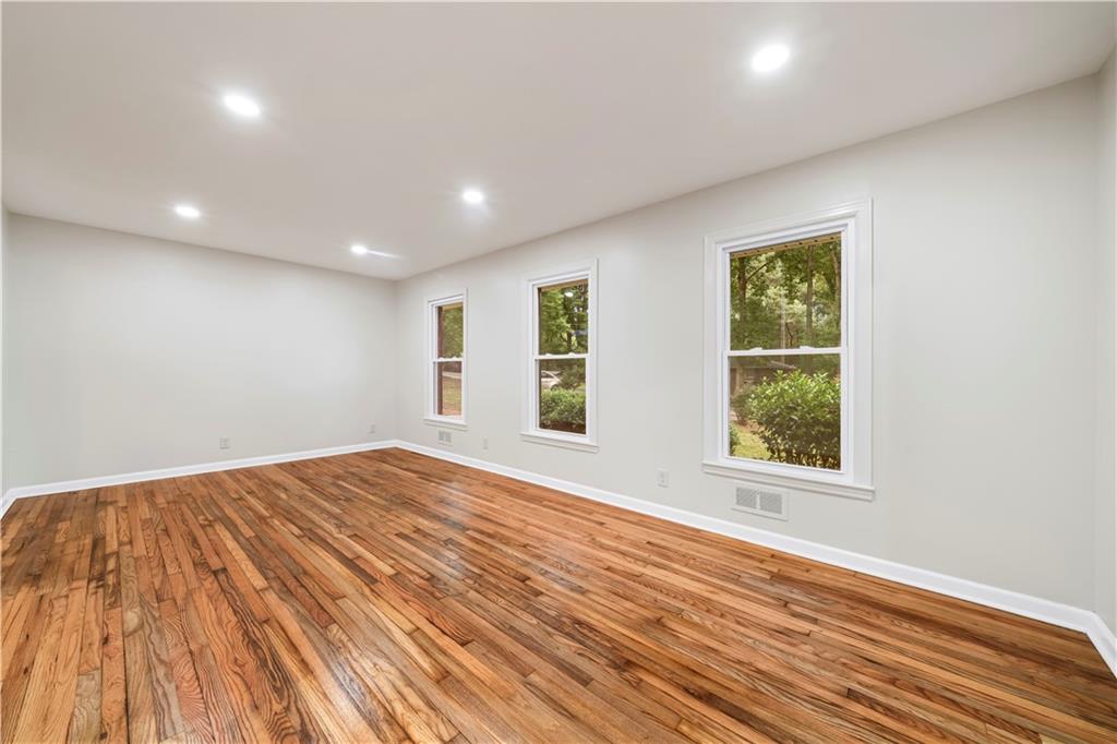 23 East Camelia Road Northeast Rome, GA 30161 - Photo 10 of 27 an empty room with wooden floor and windows
