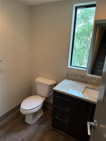 a bathroom with a toilet a sink and a window
