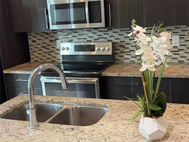 a kitchen with a sink and a stove