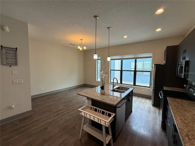 a kitchen with sink cabinets and wooden floor