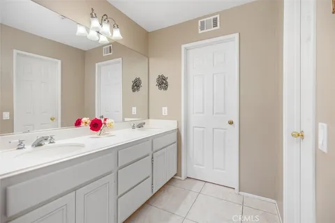 a bathroom with a sink vanity and a mirror