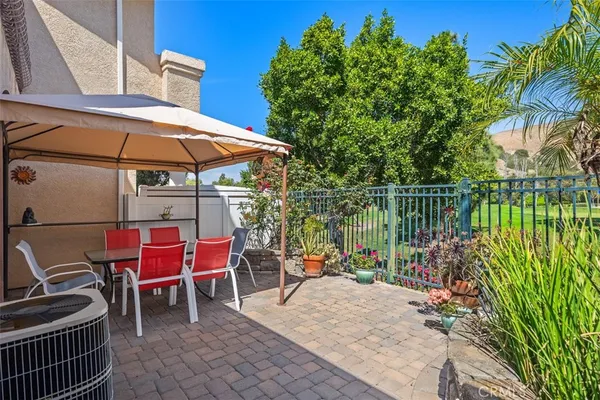 a view of a patio with a table chairs and a table