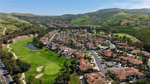 an aerial view of residential house with parking space and mountain view