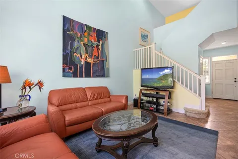 a living room with furniture a rug and a window