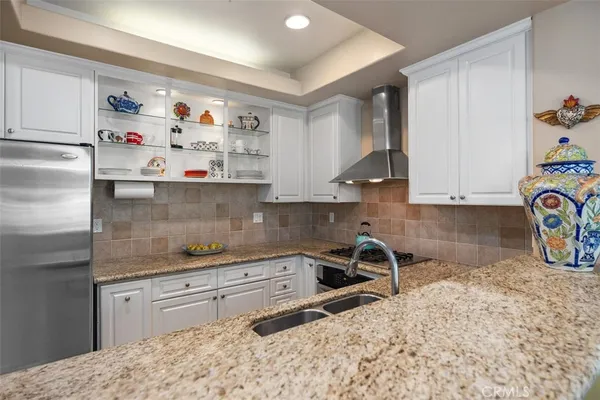 a kitchen with stainless steel appliances granite countertop a sink stove and cabinets