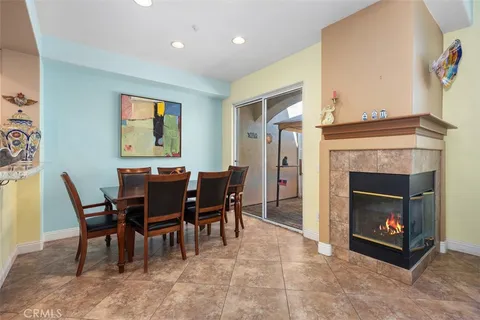 a view of a dining room with furniture and a fireplace