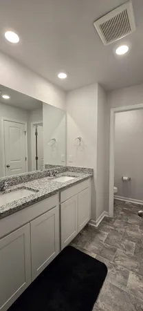 a bathroom with double vanity and a sink