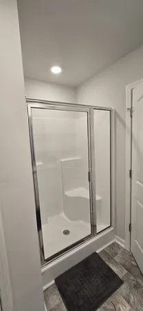 a bathroom with a glass shower door