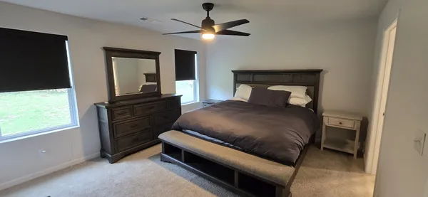 a bedroom with a bed and a chandelier