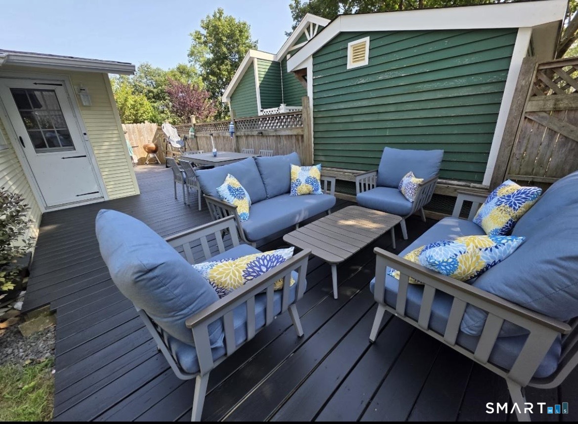 7 3rd Street, Unit 7 Madison, CT 06443 - Photo 39 of 44 a view of a patio with couches and a potted plant on a table and chairs