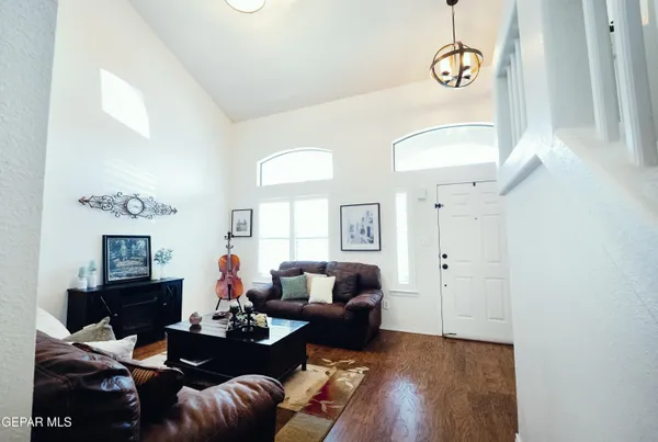a living room with furniture kitchen view and a window