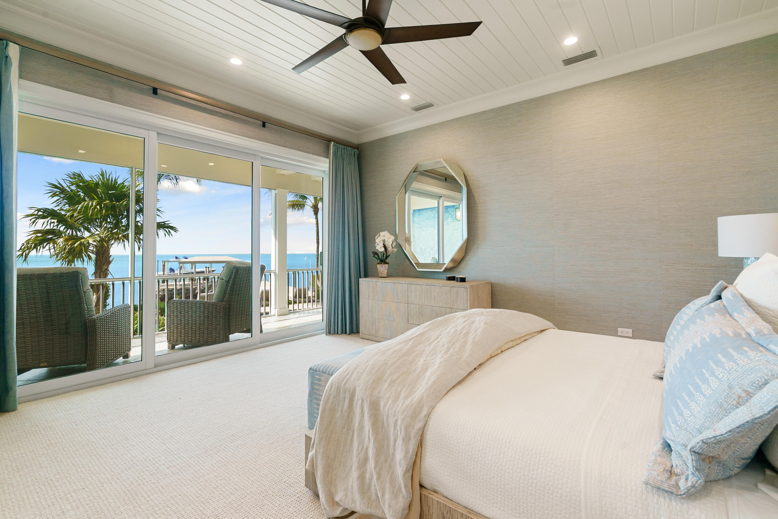 134 North Rolling Hill Road Tavernier, FL 33070 - Photo 24 of 65 a bedroom with a bed a mirror and a large window with balcony view