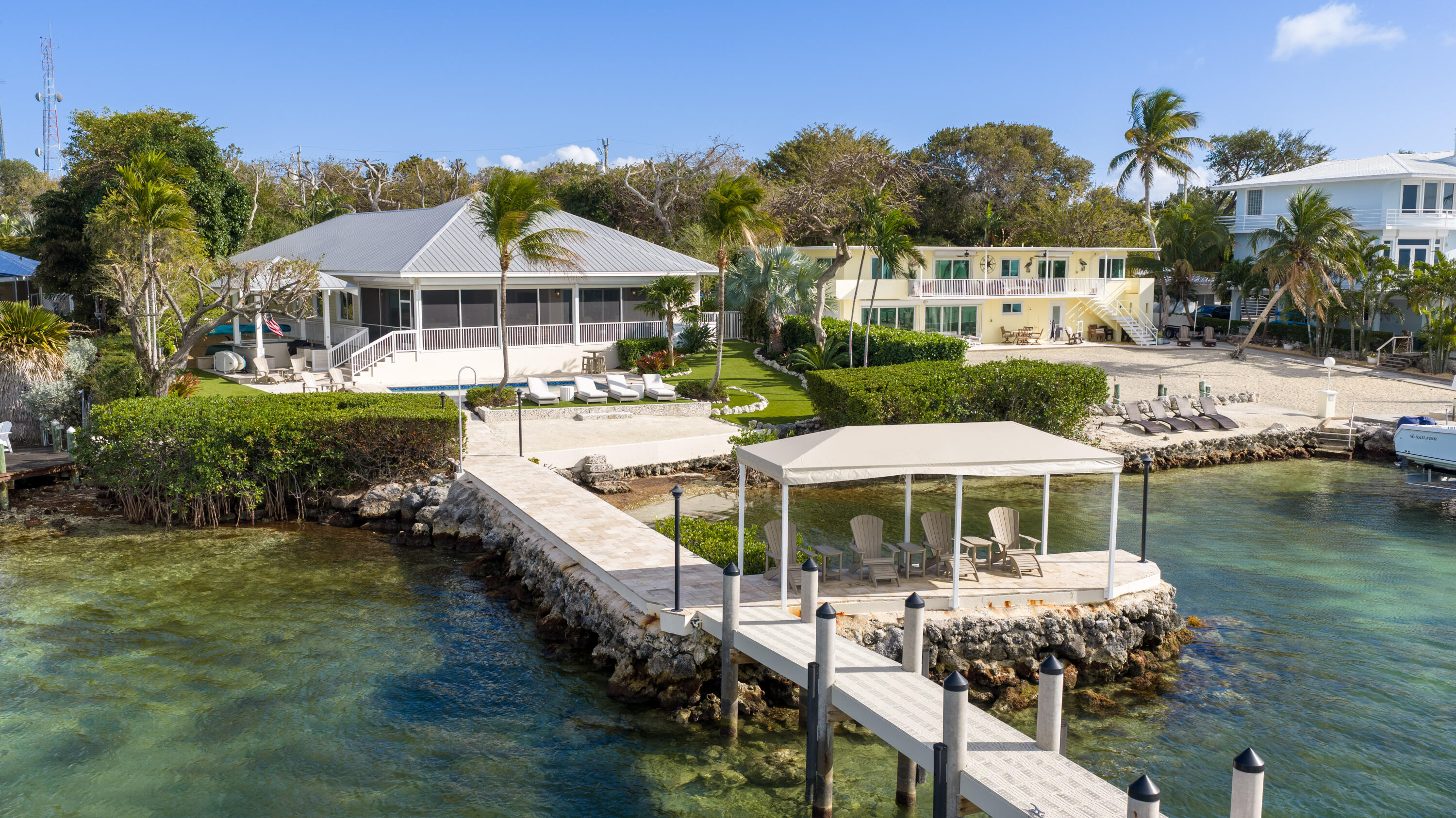134 North Rolling Hill Road Tavernier, FL 33070 - Photo 8 of 65 a patio with sofas fire pit table and chairs