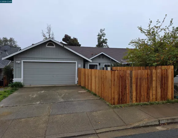 a front view of a house with wooden fence