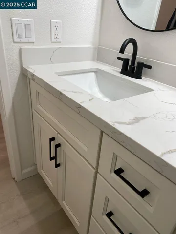 a living room with furniture a table and kitchen view