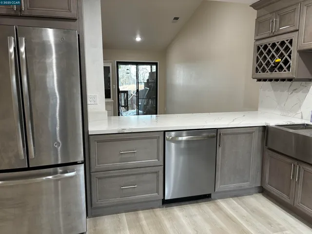 a kitchen with a refrigerator and a sink