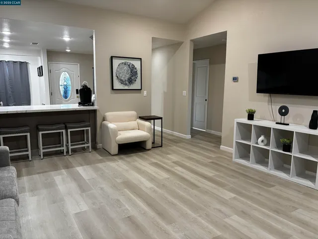 a view of empty room with wooden floor