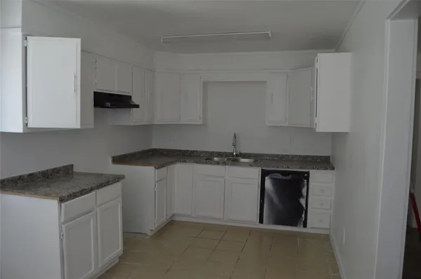 a kitchen with stainless steel appliances granite countertop a sink and a stove