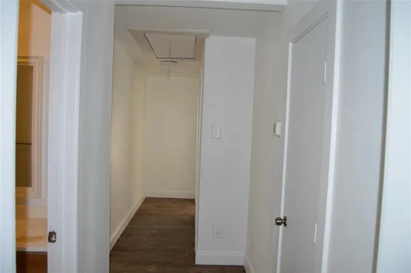 a view of a hallway with the wooden floor