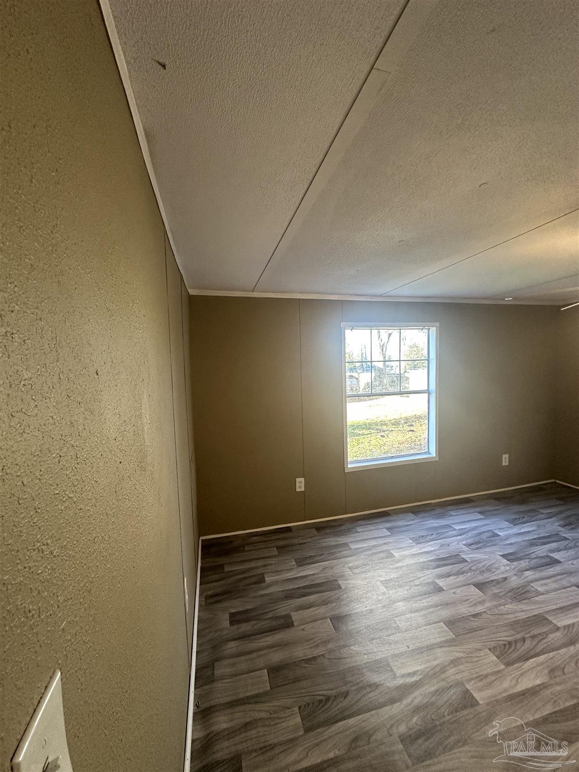 2866 Pine Forest Road, Unit 7 Cantonment, FL 32533 - Photo 10 of 17 a view of an empty room with a window