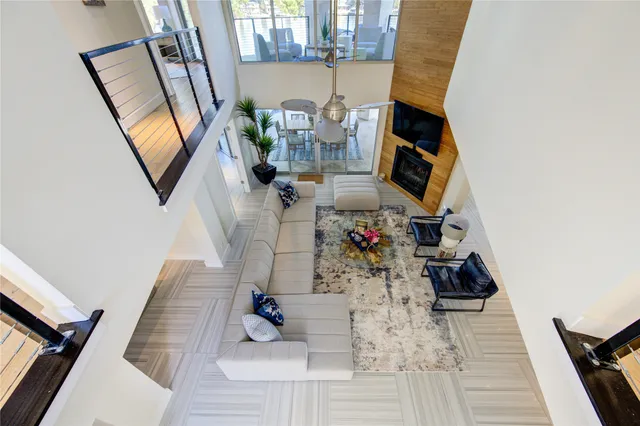 a view of staircase with lots of frames on wall and a potted plant