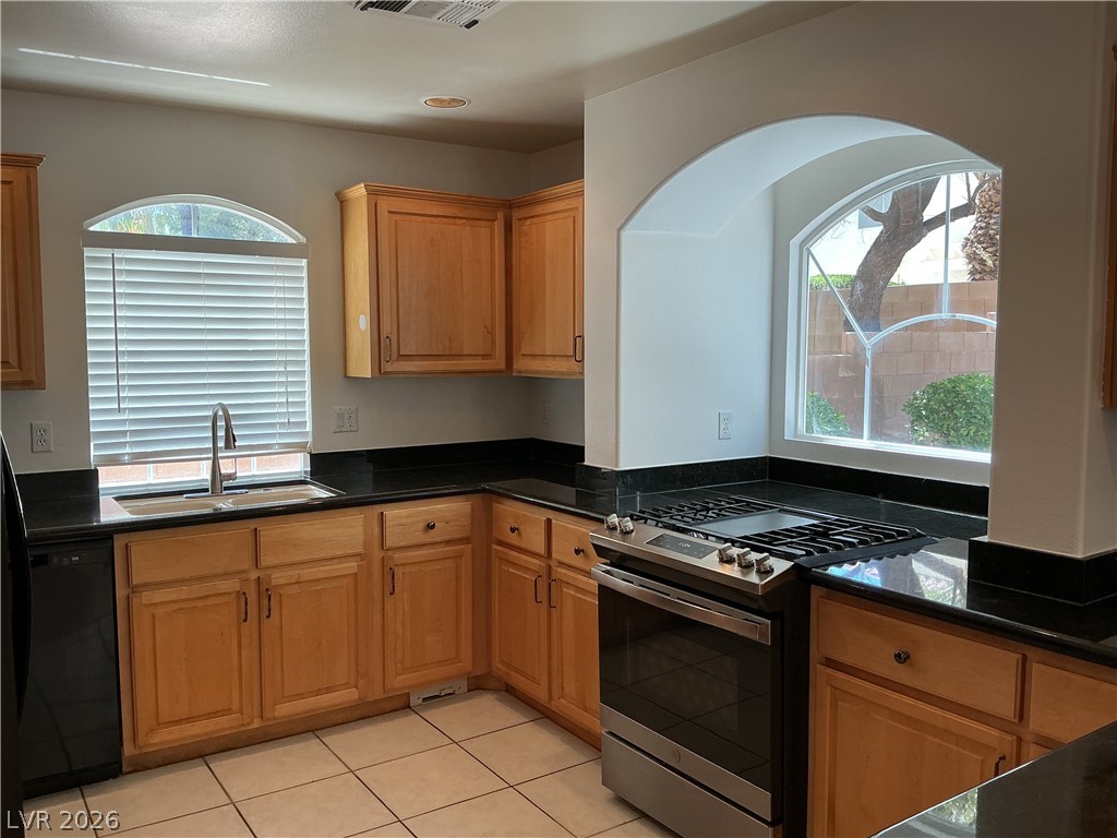 10975 Calcedonian Street Las Vegas, NV 89141 - Photo 3 of 25 This kitchen features sleek countertops and modern appliances, offering functionality and style.