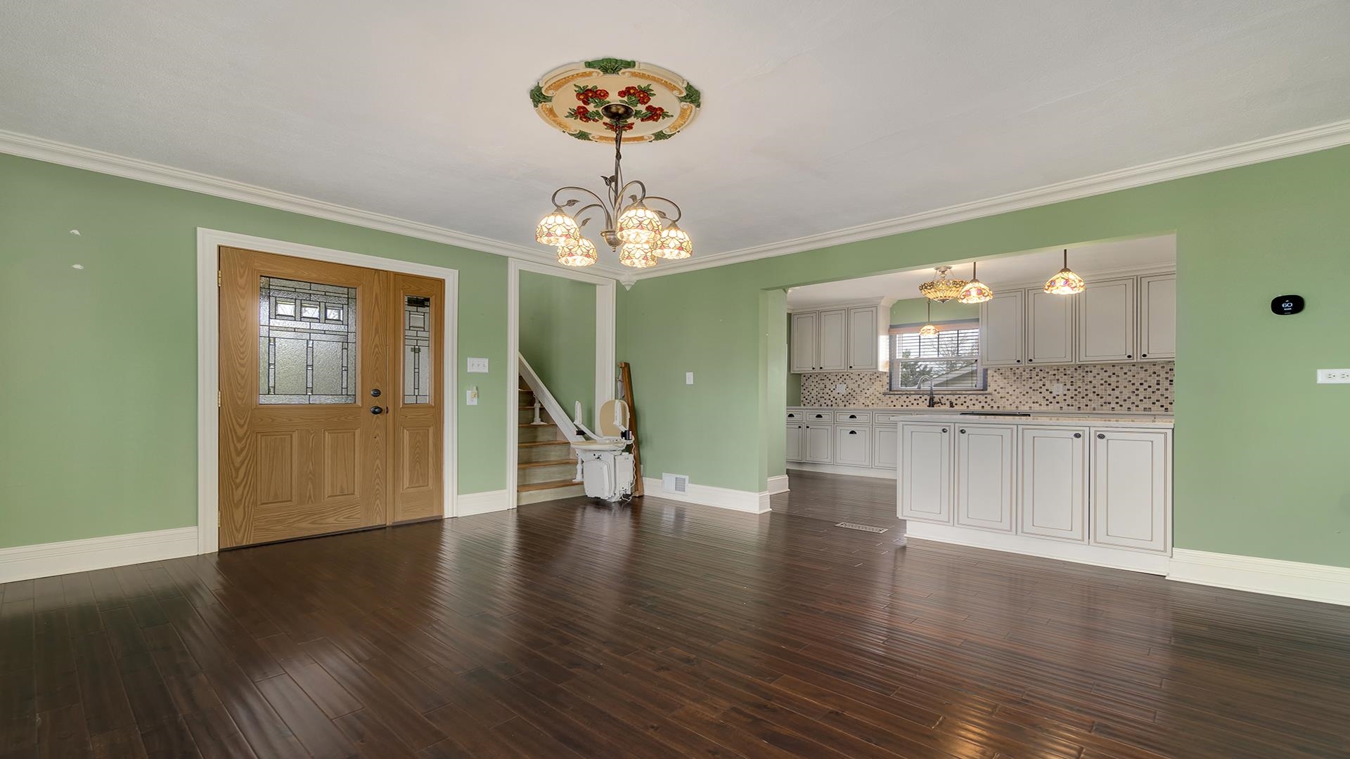 3927 Mill Road Cherry Valley, IL 61016 - Photo 11 of 36 a view of a hallway with wooden floor and a kitchen