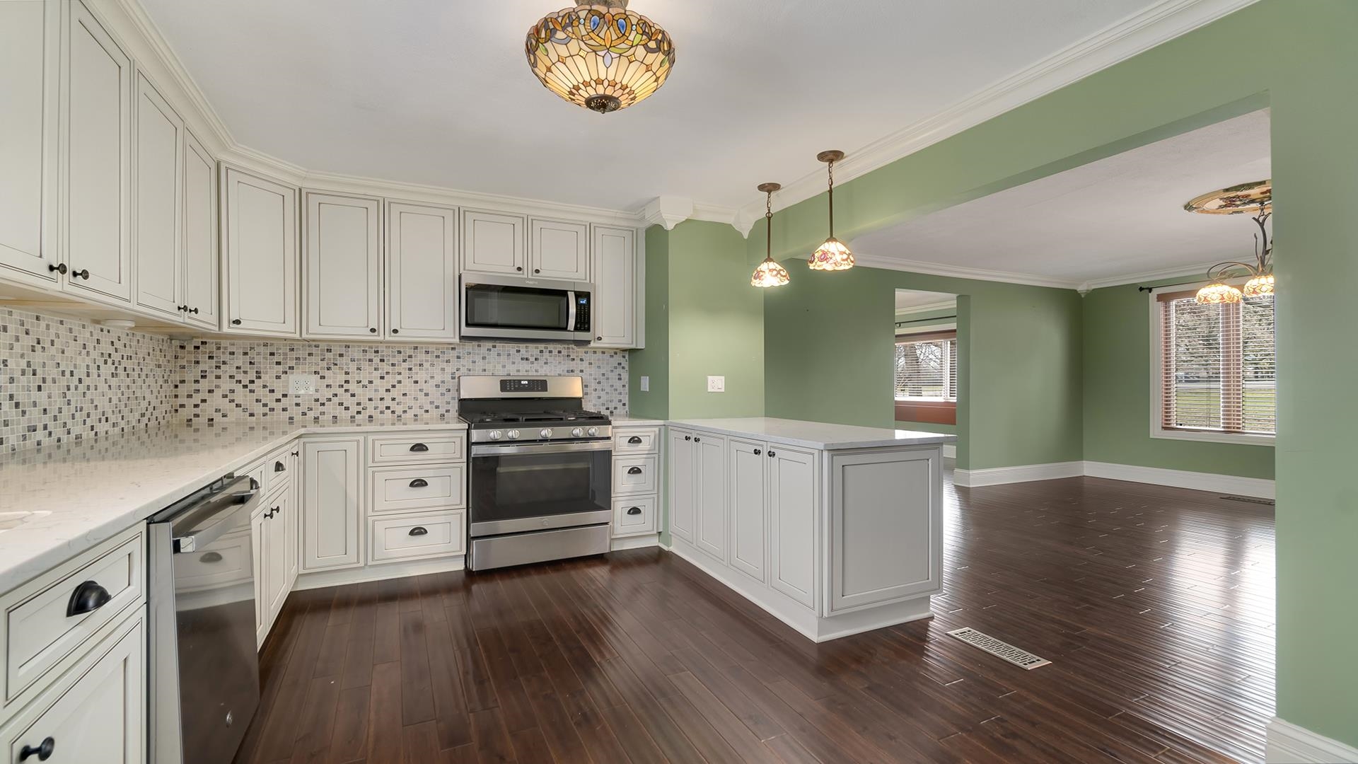 3927 Mill Road Cherry Valley, IL 61016 - Photo 12 of 36 a kitchen with white cabinets and stainless steel appliances