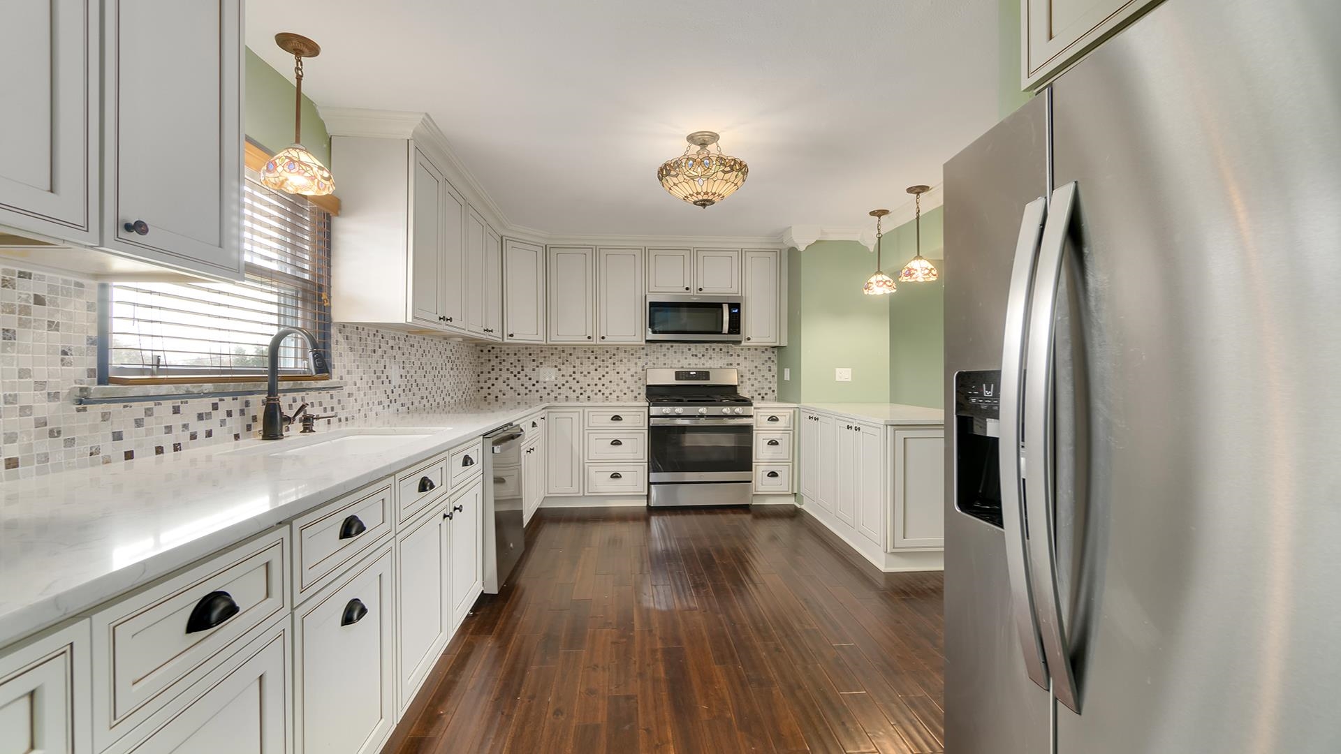 3927 Mill Road Cherry Valley, IL 61016 - Photo 13 of 36 a kitchen with stainless steel appliances a refrigerator sink and microwave