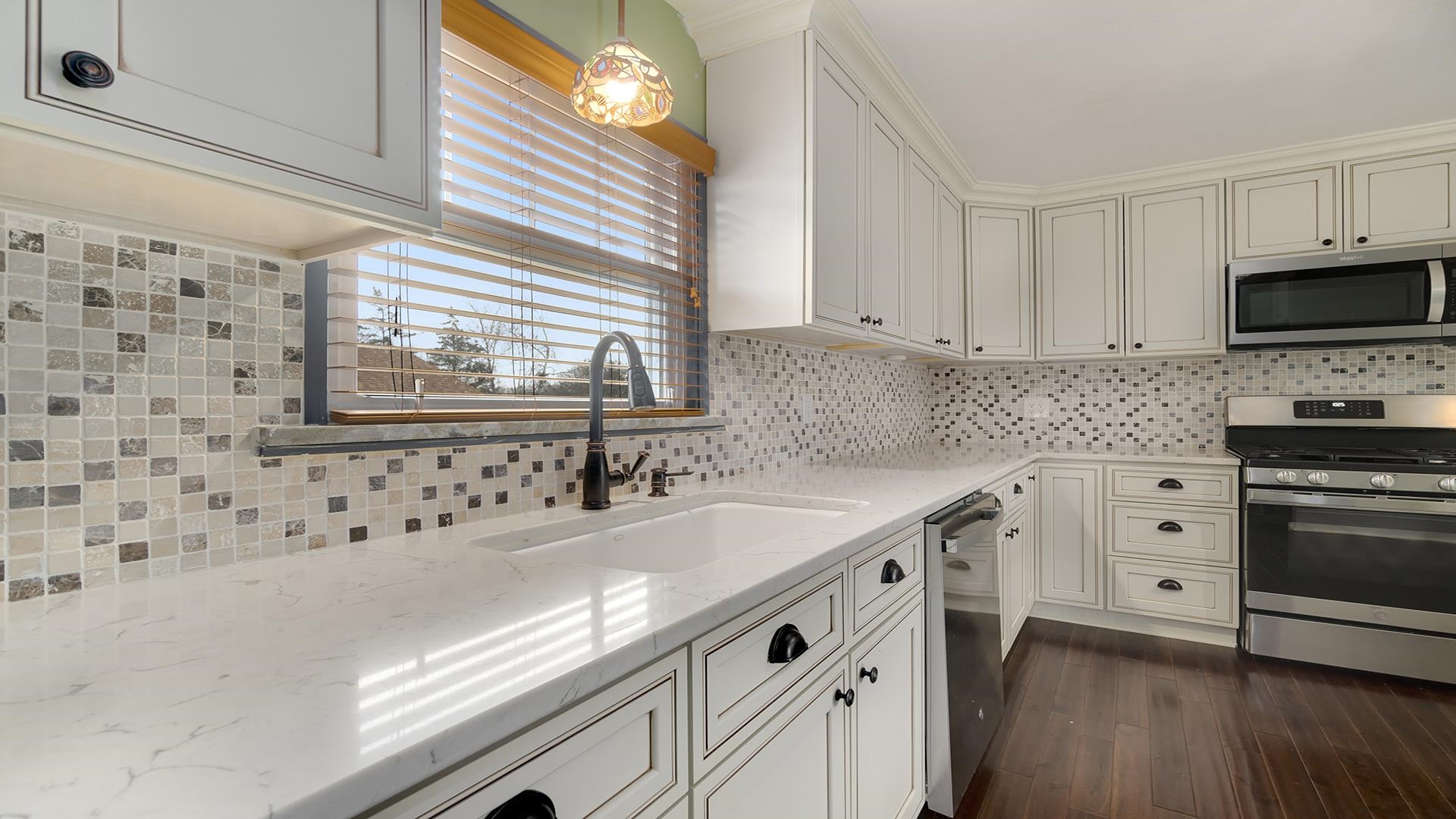 3927 Mill Road Cherry Valley, IL 61016 - Photo 15 of 36 a kitchen with granite countertop a sink and a stove top oven