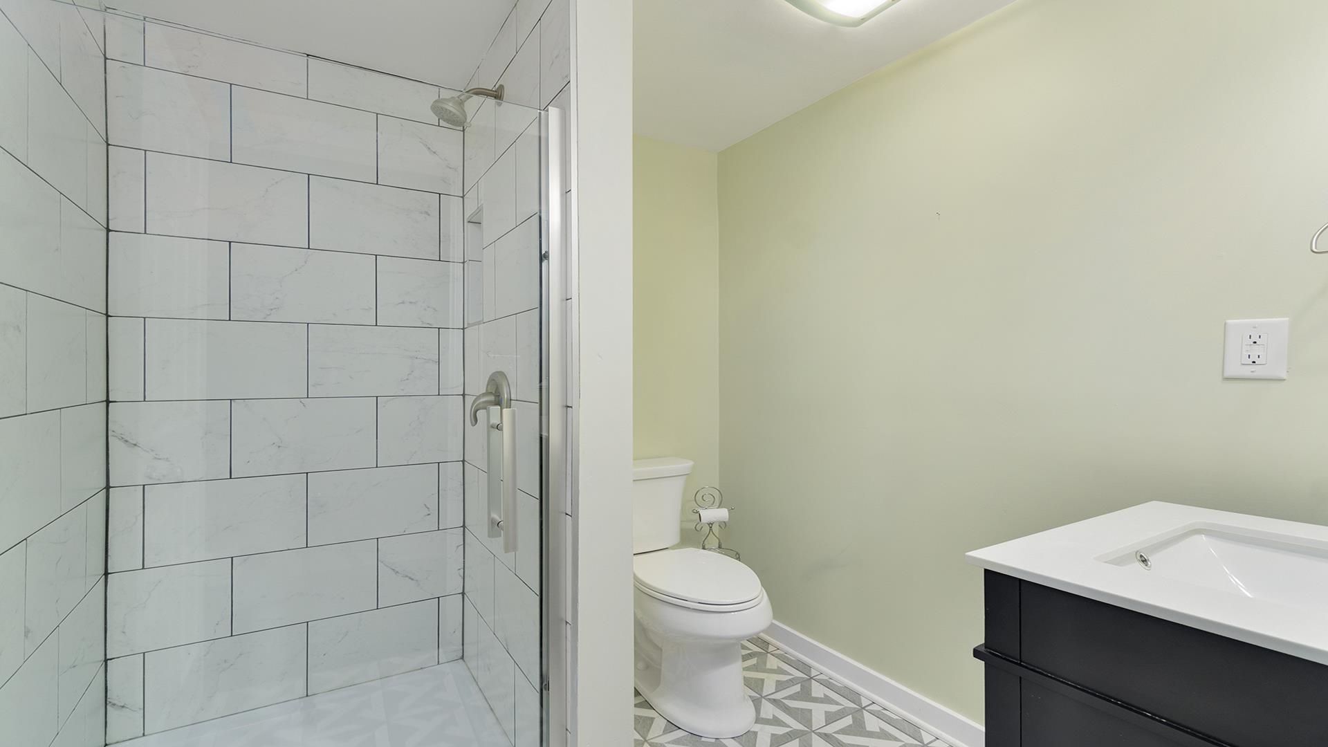 3927 Mill Road Cherry Valley, IL 61016 - Photo 16 of 36 a bathroom with a toilet and a shower