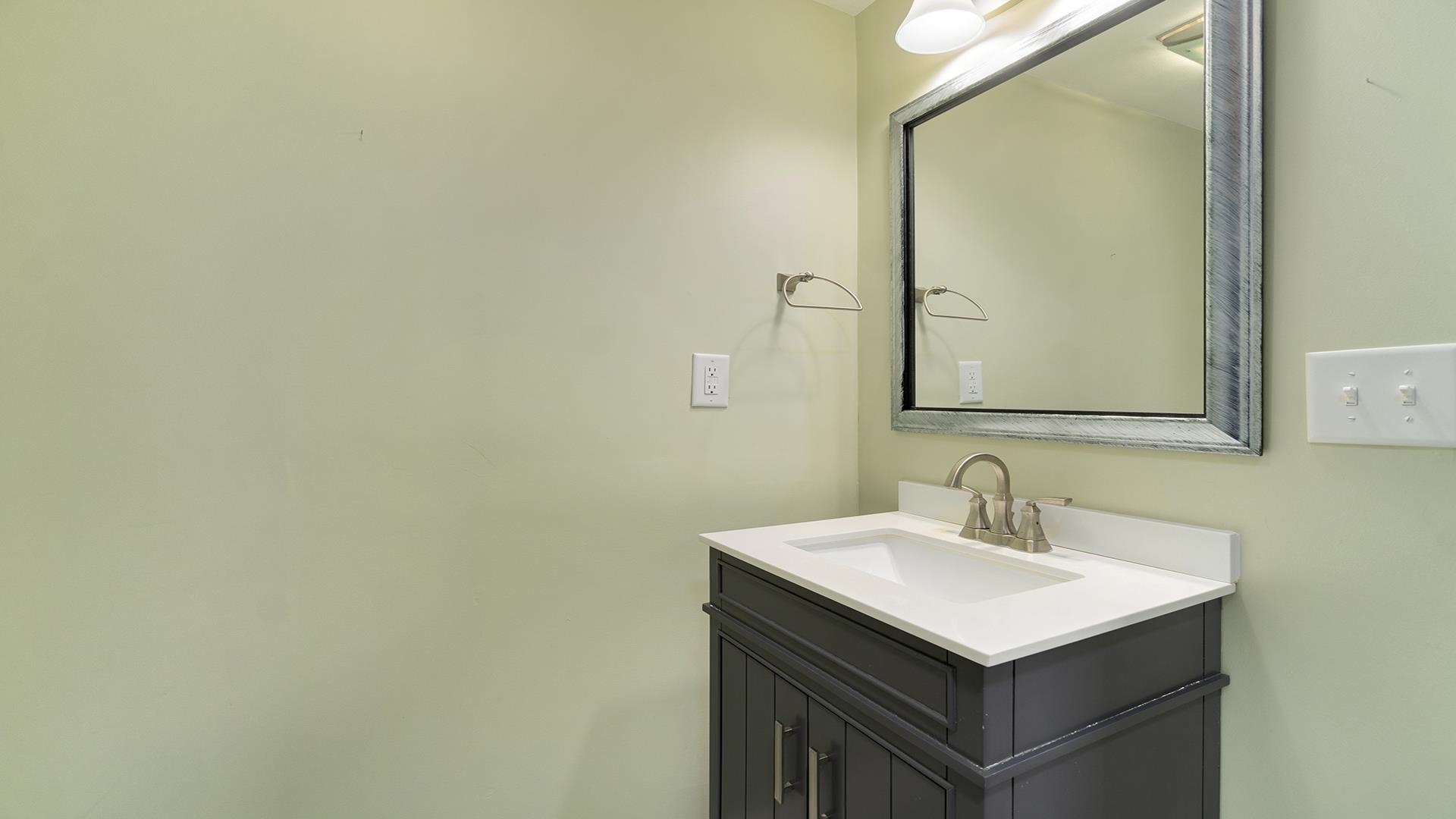 3927 Mill Road Cherry Valley, IL 61016 - Photo 17 of 36 a bathroom with a sink and a mirror