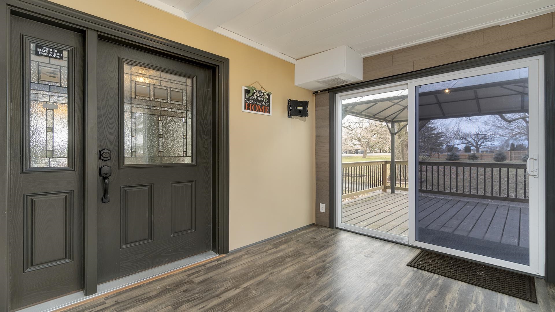 3927 Mill Road Cherry Valley, IL 61016 - Photo 19 of 36 a view of a room with wooden floor and windows