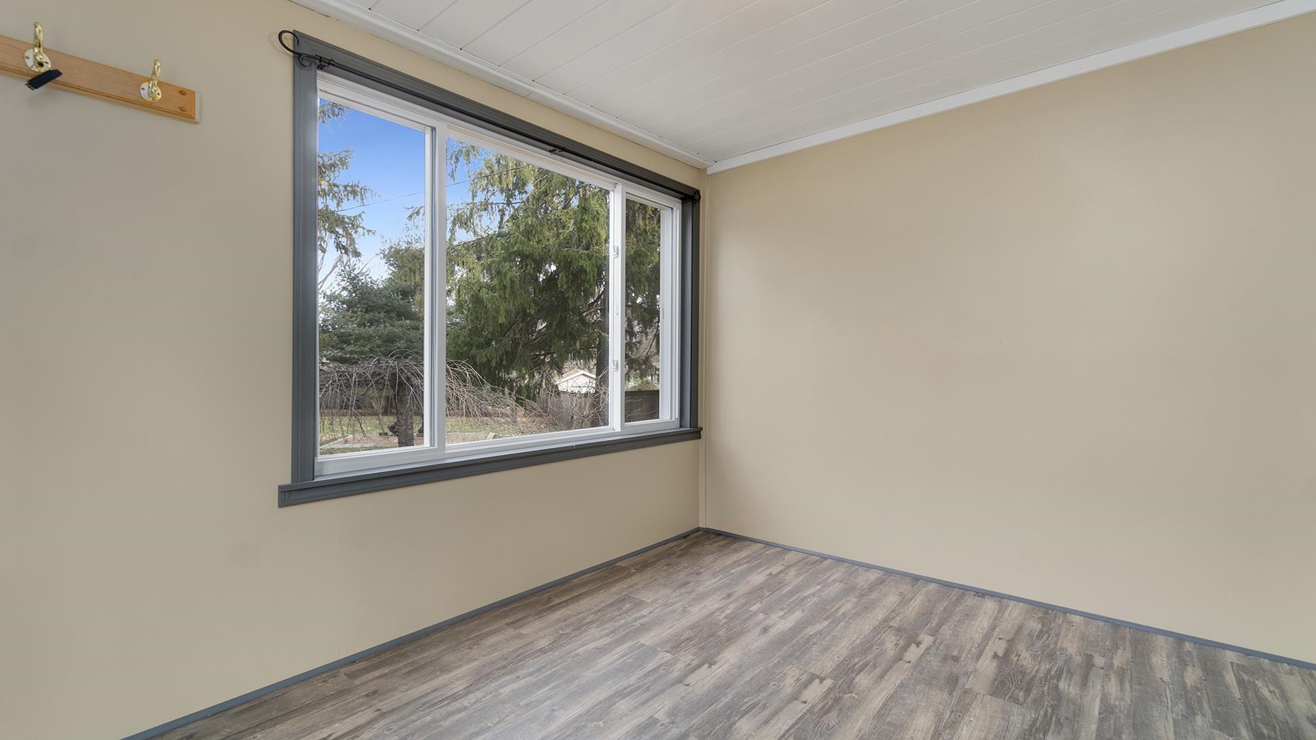 3927 Mill Road Cherry Valley, IL 61016 - Photo 20 of 36 a view of empty room with wooden floor and fan