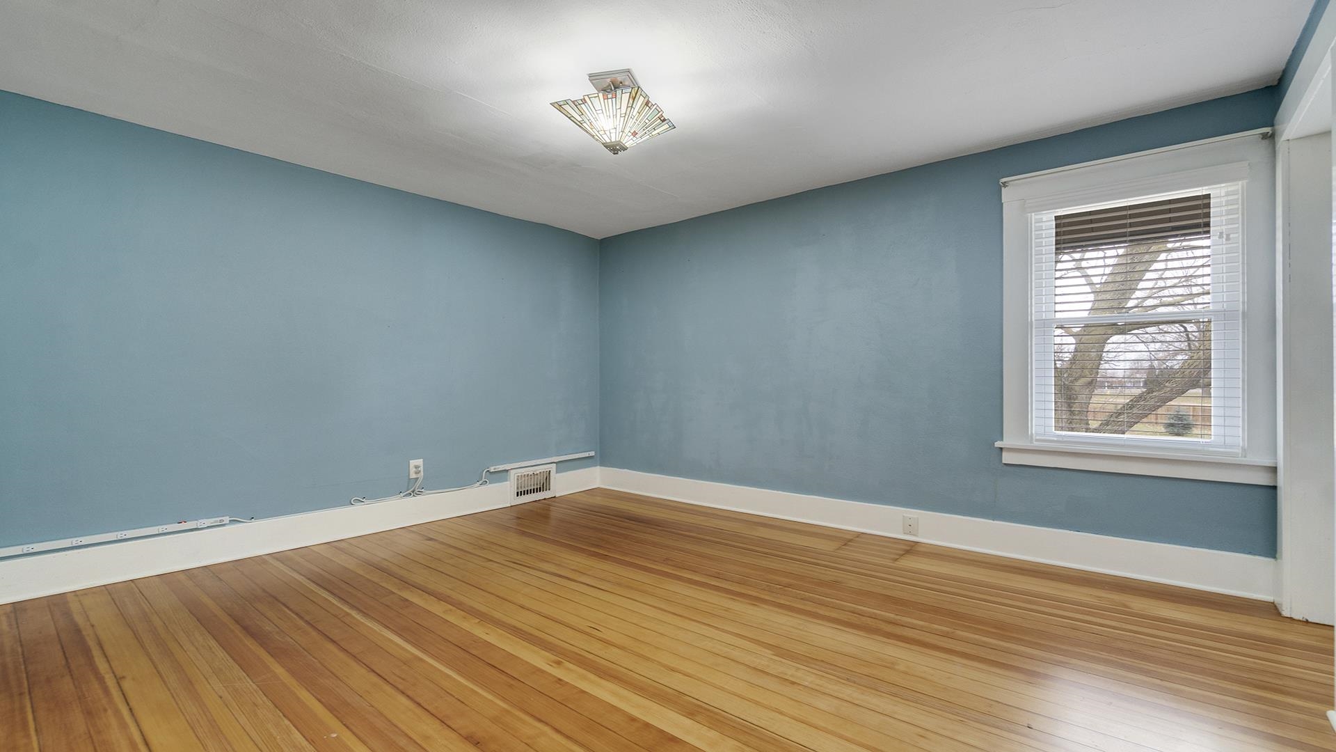 3927 Mill Road Cherry Valley, IL 61016 - Photo 24 of 36 wooden floor in an empty room with a window