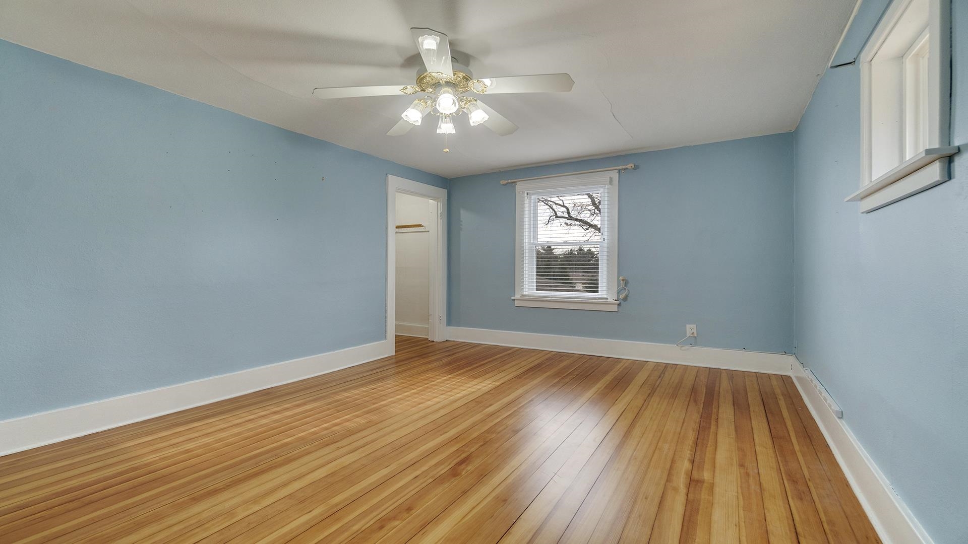 3927 Mill Road Cherry Valley, IL 61016 - Photo 25 of 36 a view of an empty room with wooden floor and a window