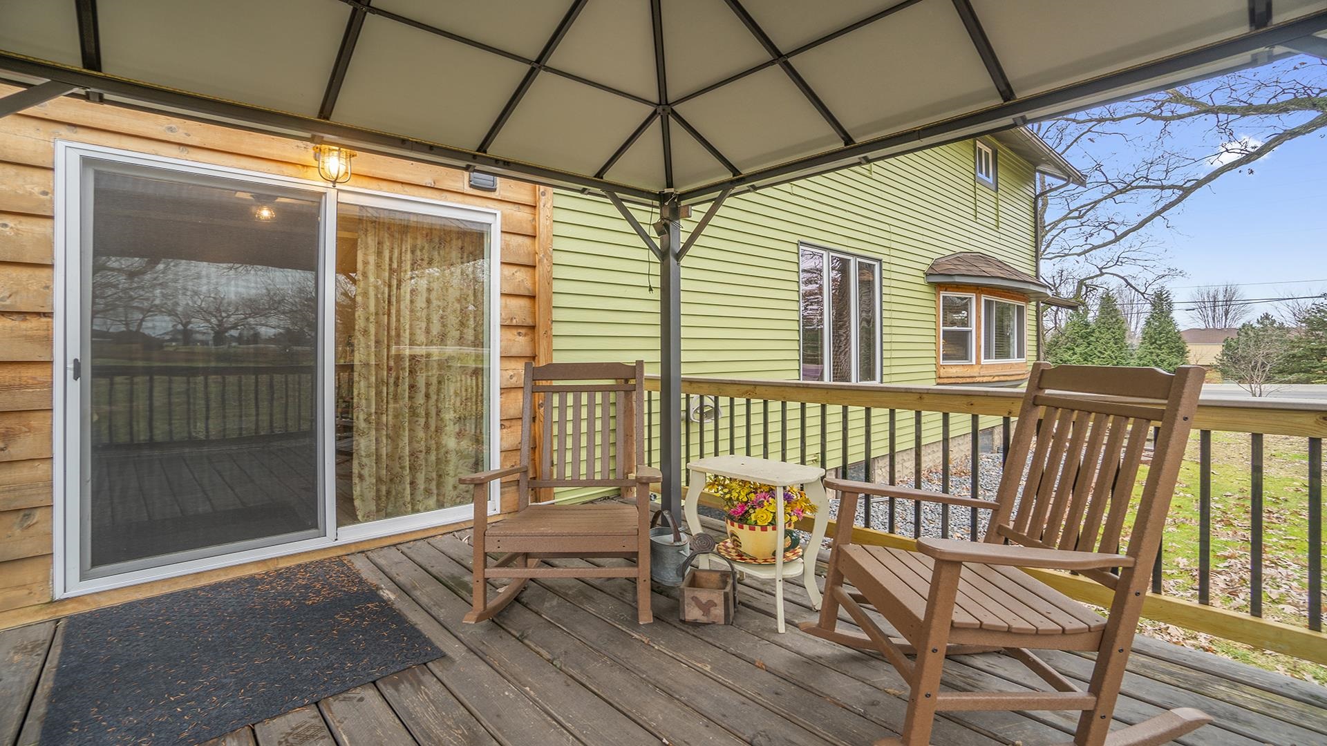 3927 Mill Road Cherry Valley, IL 61016 - Photo 31 of 36 a porch area with table and chairs