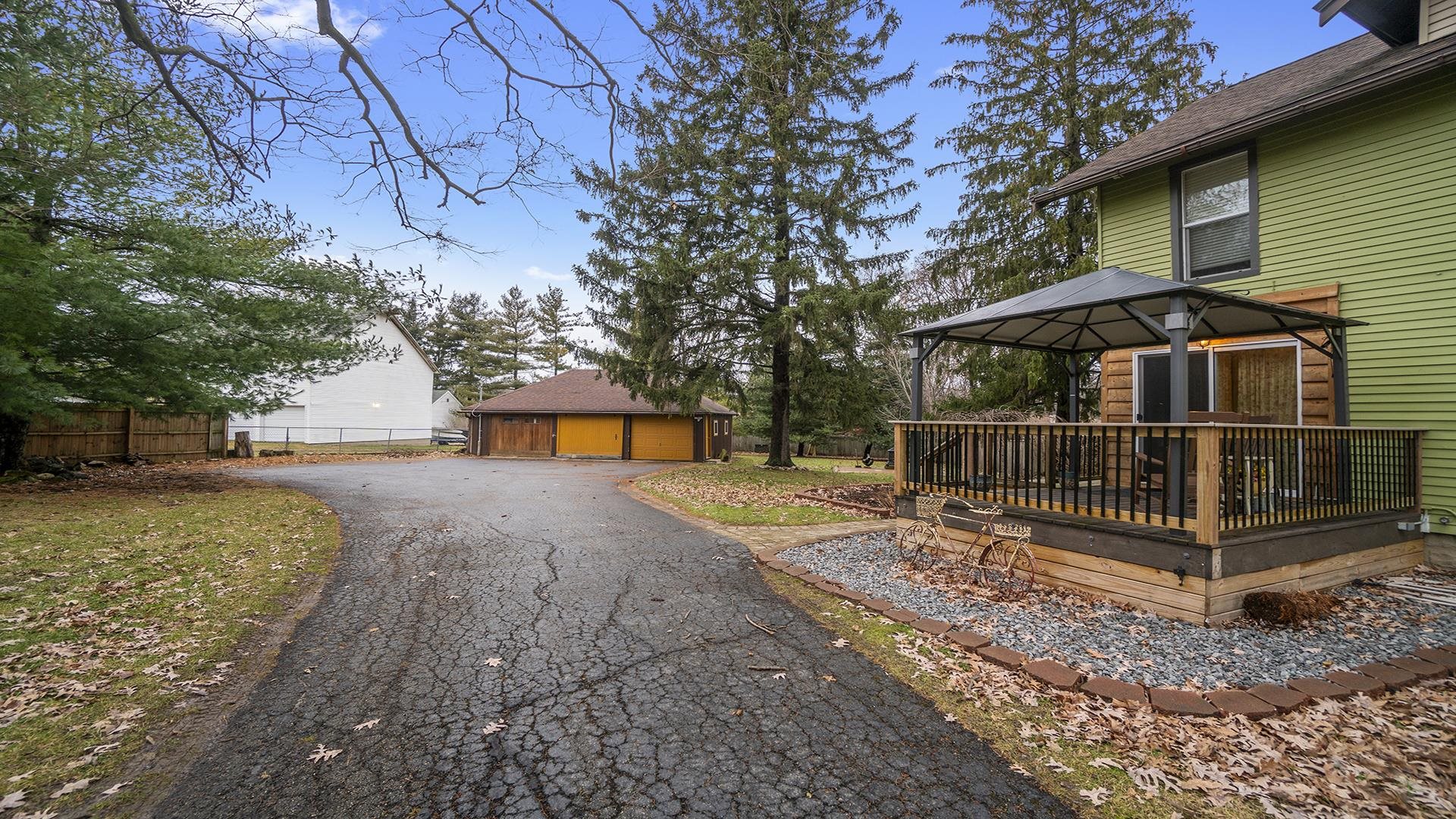 3927 Mill Road Cherry Valley, IL 61016 - Photo 35 of 36 a view of a yard with wooden fence and a bench