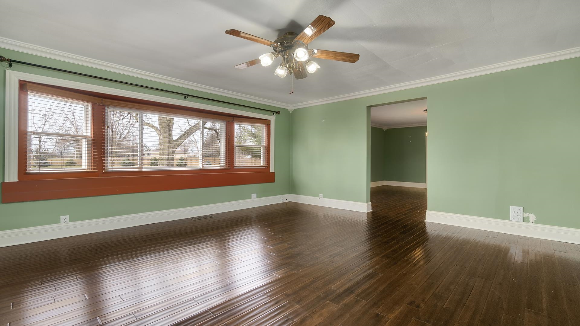 3927 Mill Road Cherry Valley, IL 61016 - Photo 5 of 36 a view of an empty room with window and wooden floor