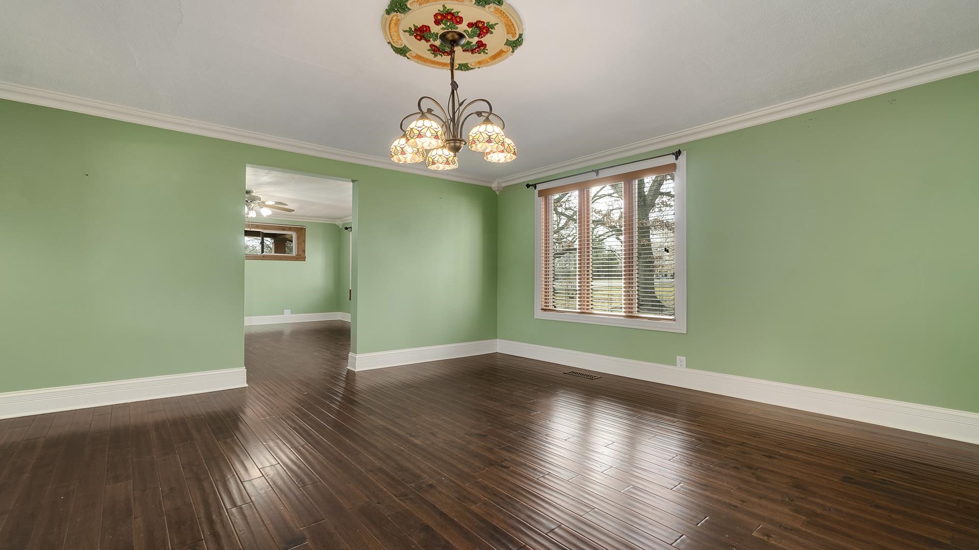3927 Mill Road Cherry Valley, IL 61016 - Photo 7 of 36 a view of an empty room with wooden floor and a window