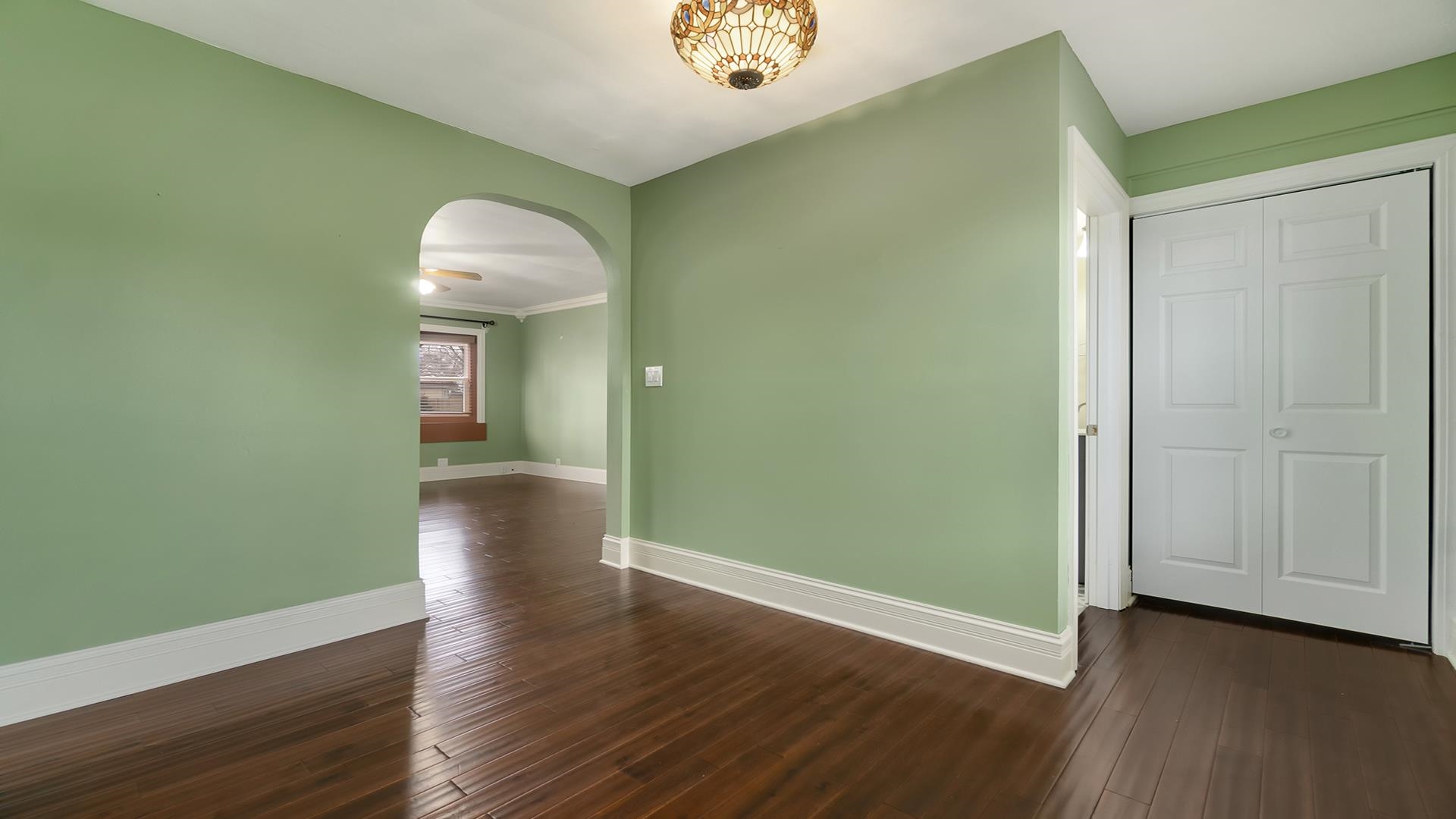 3927 Mill Road Cherry Valley, IL 61016 - Photo 8 of 36 an empty room with wooden floor and windows