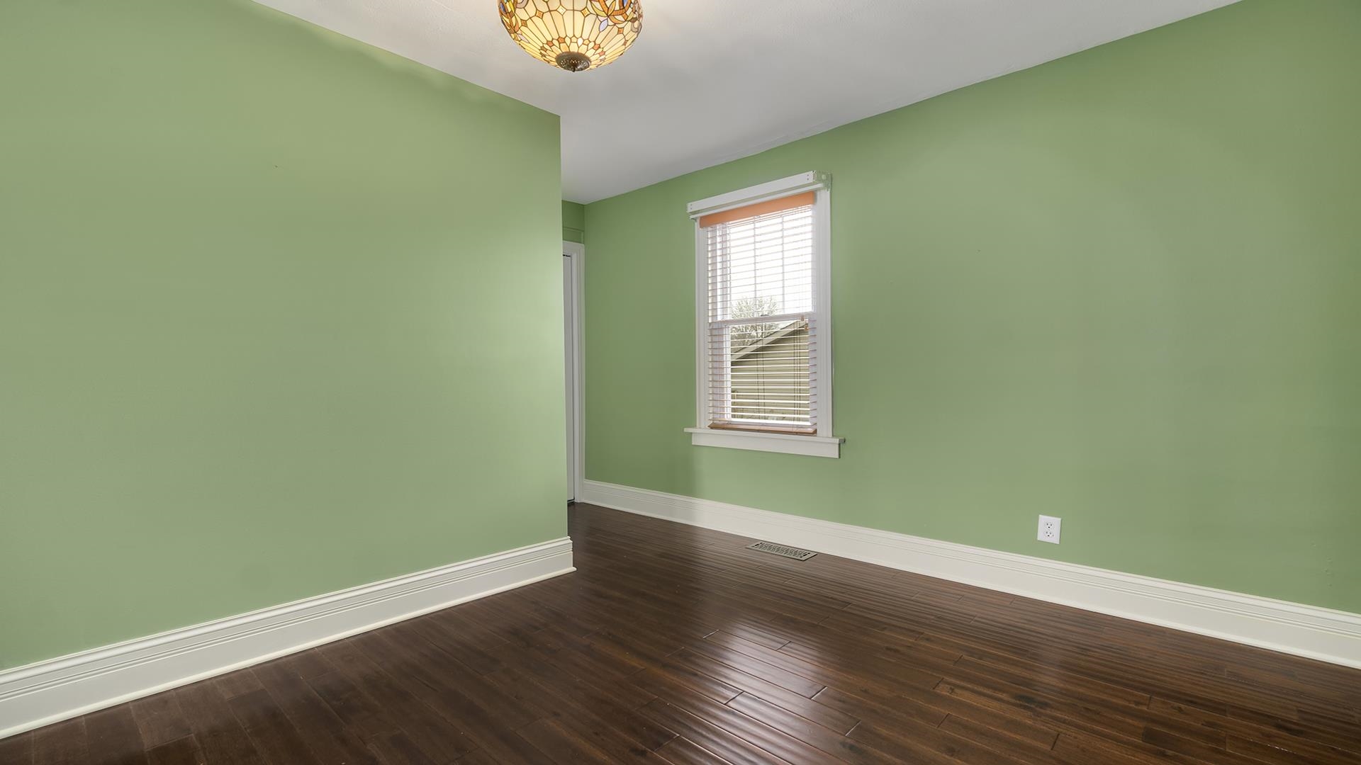 3927 Mill Road Cherry Valley, IL 61016 - Photo 9 of 36 an empty room with wooden floor and windows