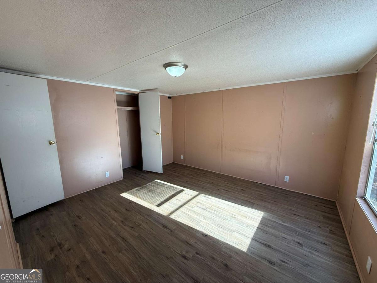 129 Elza Drive Cleveland, GA 30528 - Photo 6 of 14 an empty room with wooden floor and windows
