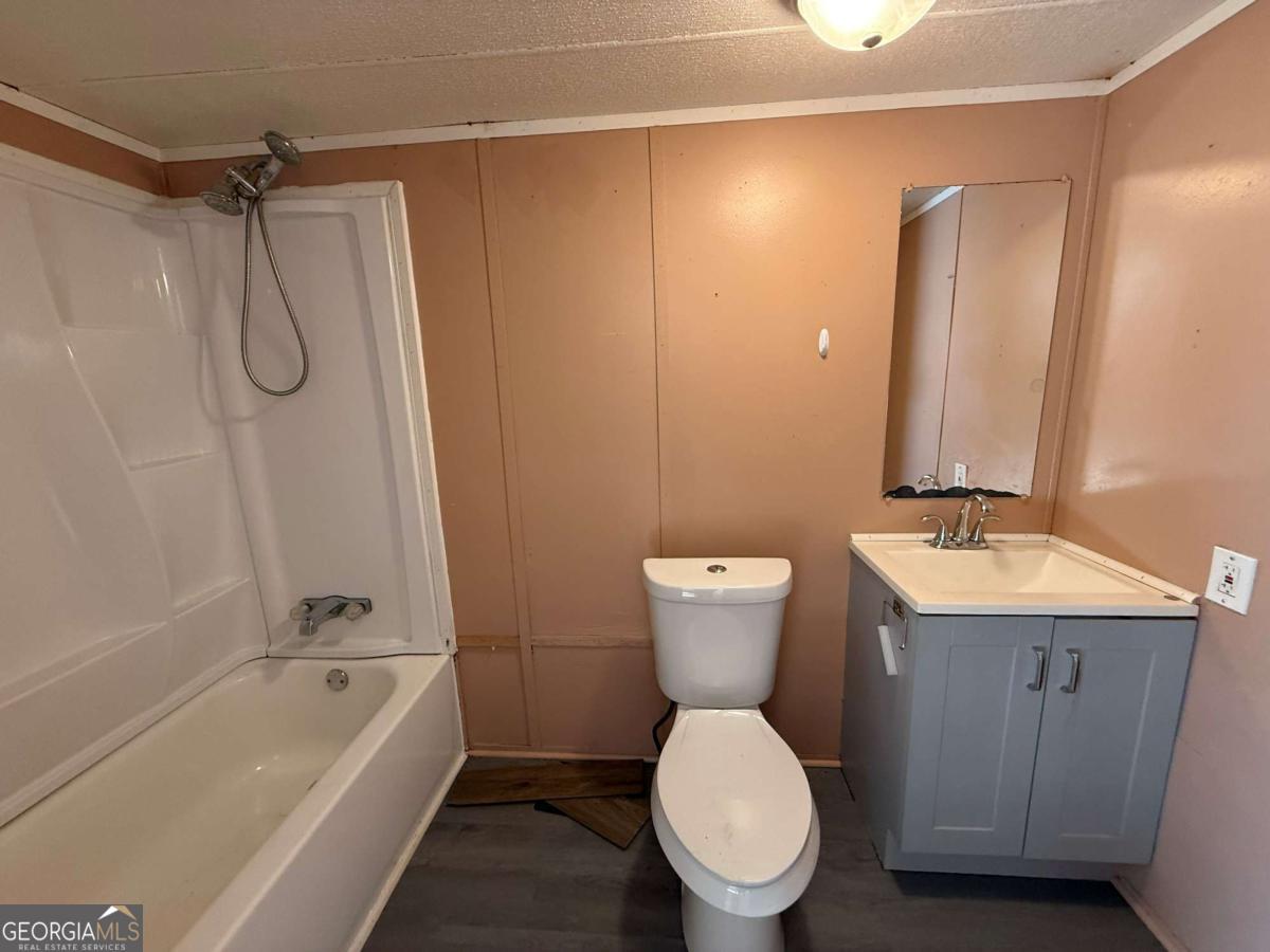 129 Elza Drive Cleveland, GA 30528 - Photo 7 of 14 a bathroom with a sink a toilet and shower