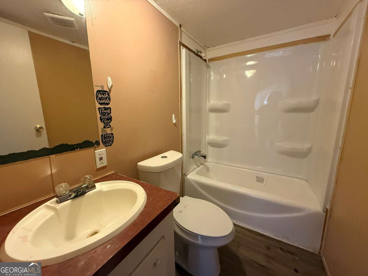 129 Elza Drive Cleveland, GA 30528 - Photo 10 of 14 a bathroom with a sink and a mirror