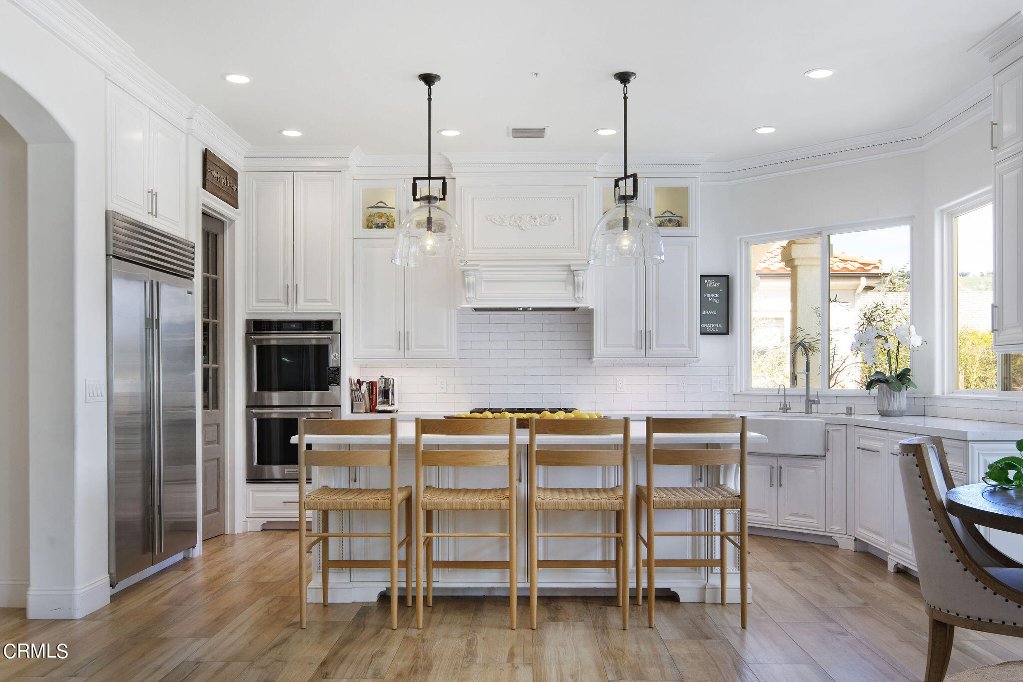 2050 Freeborn Way Camarillo, CA 93012 - Photo 11 of 61 a kitchen with kitchen island a dining table chairs stainless steel appliances and cabinets
