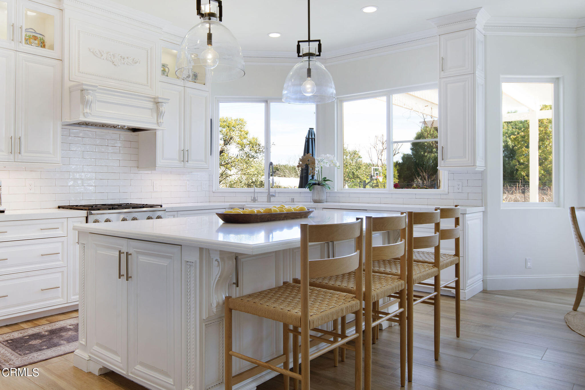 2050 Freeborn Way Camarillo, CA 93012 - Photo 13 of 61 a kitchen with stainless steel appliances granite countertop a table chairs in it and wooden floors