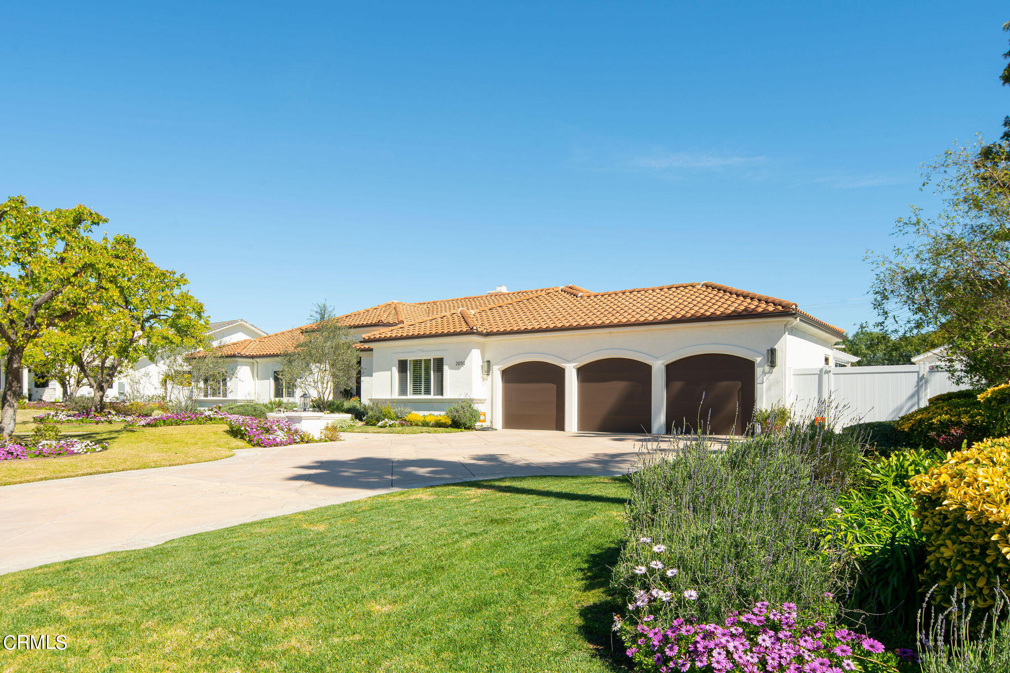 2050 Freeborn Way Camarillo, CA 93012 - Photo 59 of 61 a view of a white house with a big yard and potted plants